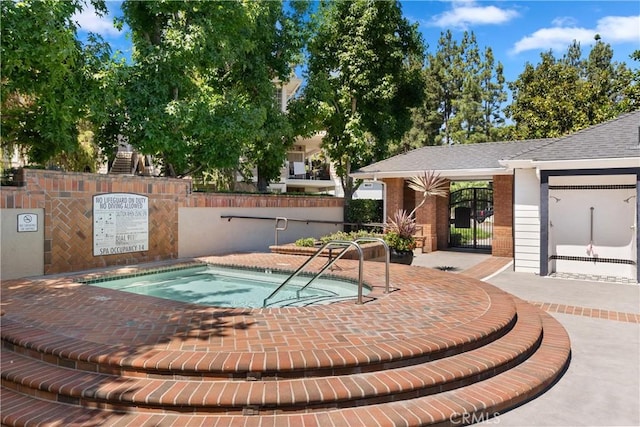 view of swimming pool with a gate and fence