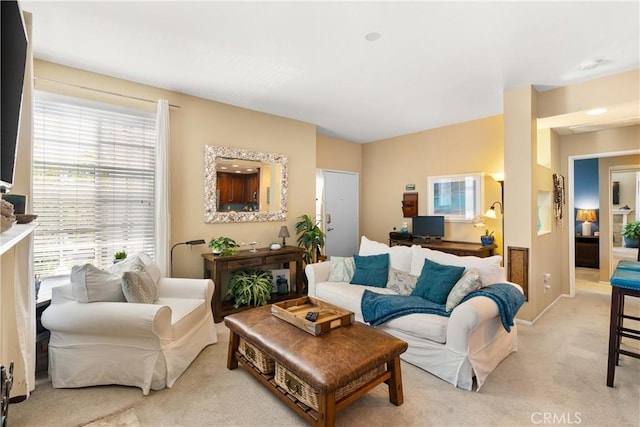 living room featuring light colored carpet and baseboards