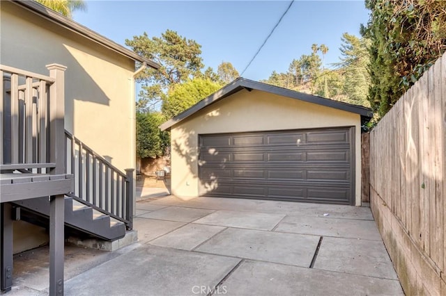 detached garage featuring fence