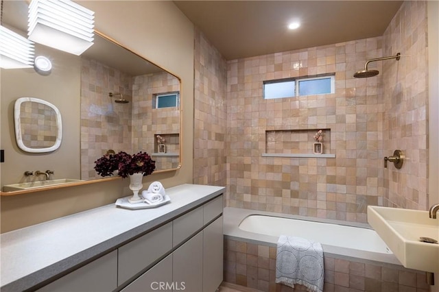 full bathroom featuring tiled shower / bath and a sink