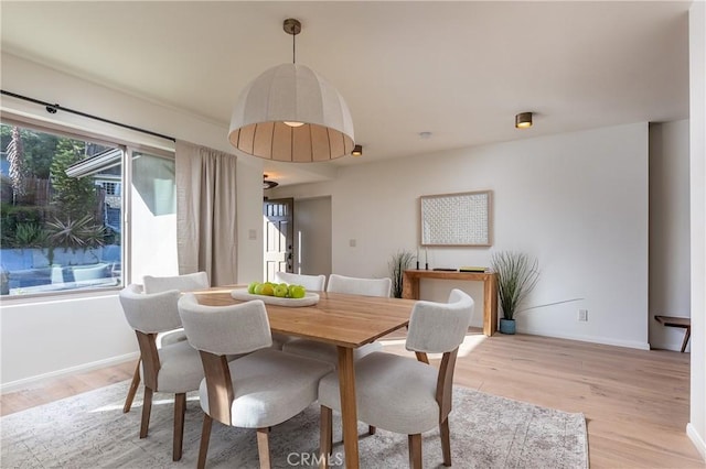 dining room with light wood-style flooring and baseboards