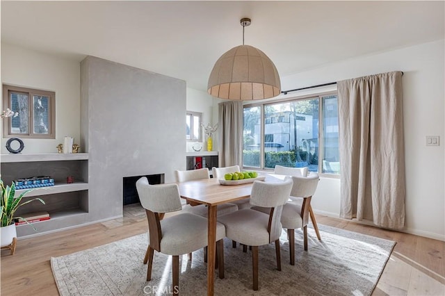 dining area with wood finished floors and baseboards