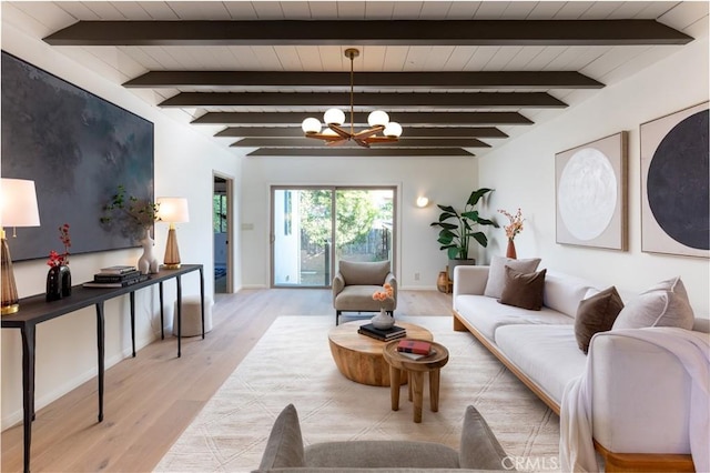 living area featuring baseboards, beamed ceiling, light wood-style flooring, and a notable chandelier