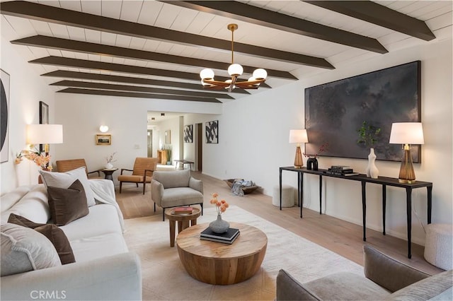 living area featuring a notable chandelier and beamed ceiling