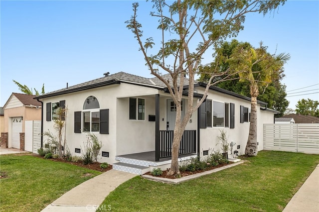 bungalow-style home with a front lawn, crawl space, fence, and stucco siding