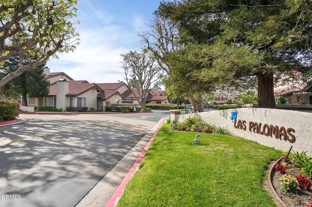 exterior space featuring curbs and a residential view