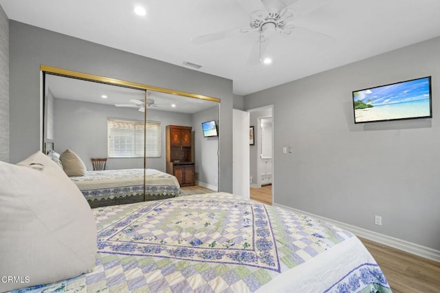 bedroom featuring recessed lighting, wood finished floors, visible vents, baseboards, and a closet