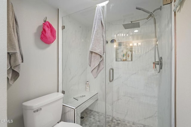 full bath featuring a marble finish shower and toilet