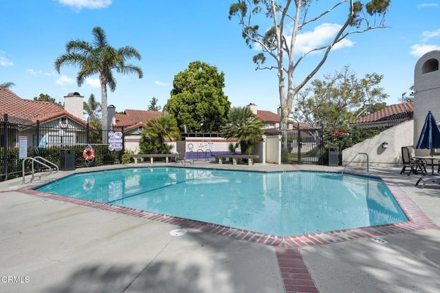 pool featuring a patio area and fence