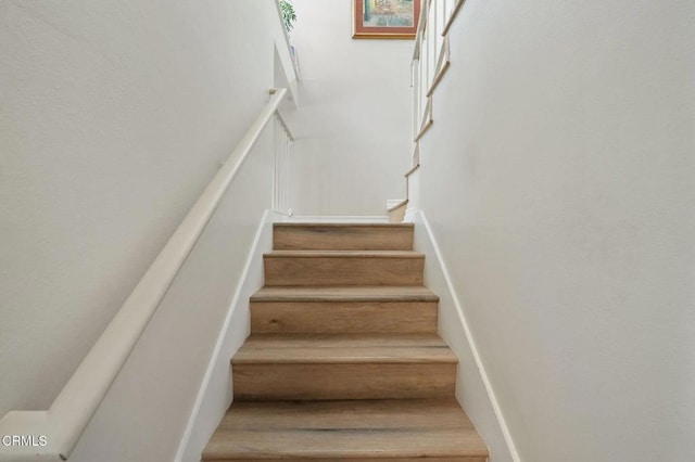 staircase featuring wood finished floors