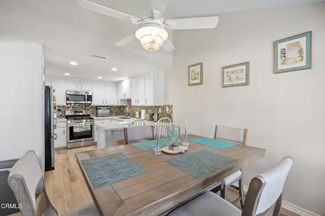 dining room with visible vents, baseboards, ceiling fan, light wood-type flooring, and recessed lighting