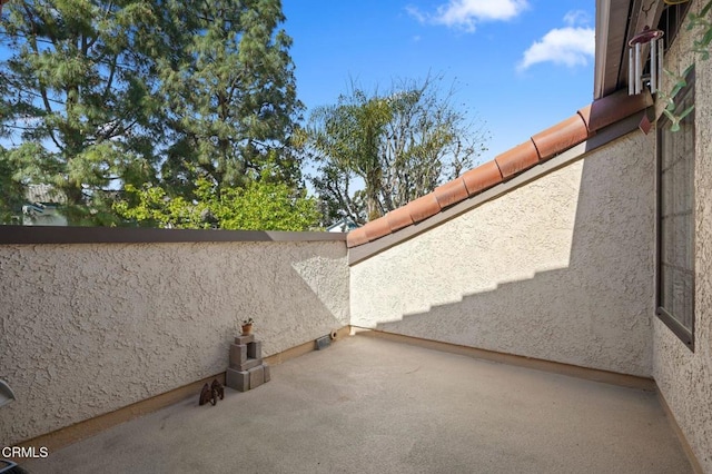 view of side of home with a patio and stucco siding