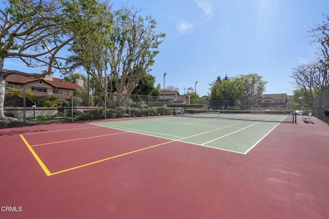 view of tennis court with fence