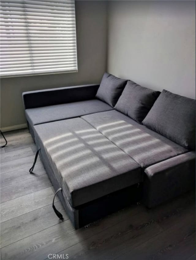 bedroom with wood finished floors and baseboards