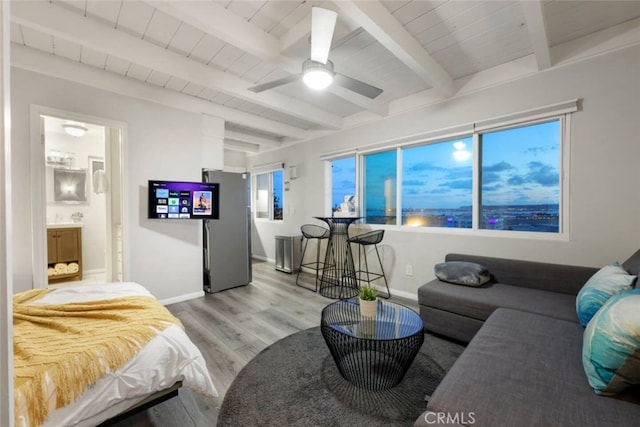 bedroom with light wood finished floors, beamed ceiling, wood ceiling, and baseboards