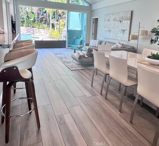 interior space featuring vaulted ceiling and wood finish floors