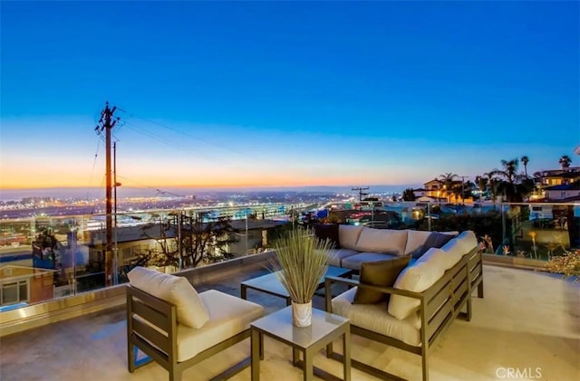 patio terrace at dusk featuring an outdoor hangout area