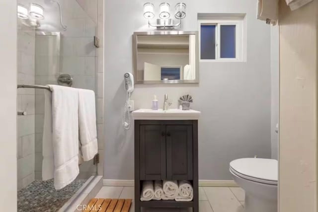 bathroom featuring a stall shower, tile patterned flooring, and baseboards