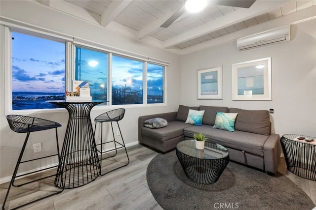 living area with wood ceiling, an AC wall unit, wood finished floors, beamed ceiling, and baseboards