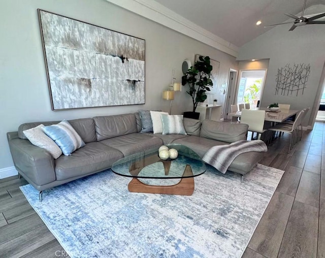 living room with vaulted ceiling, ceiling fan, wood finished floors, and baseboards