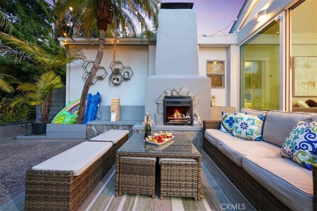 view of patio featuring an outdoor living space with a fireplace