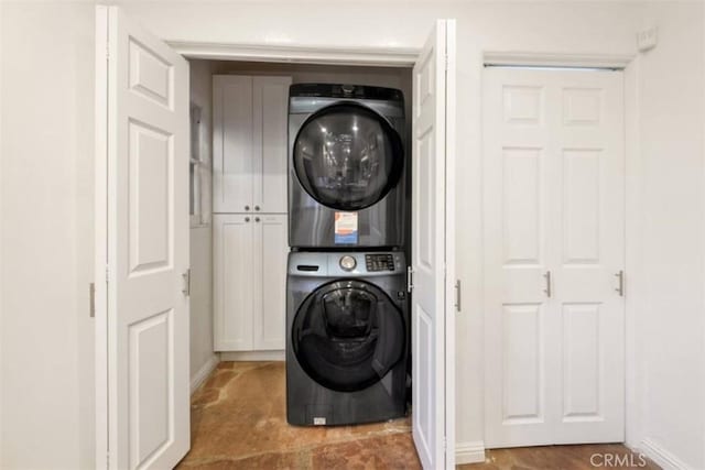 laundry room featuring laundry area and stacked washer / dryer