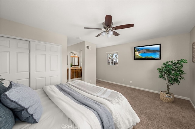 carpeted bedroom with baseboards, visible vents, ensuite bath, ceiling fan, and a closet