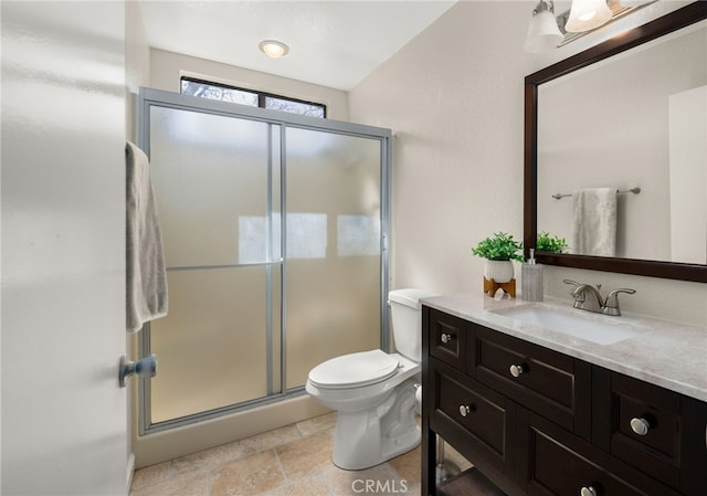 full bathroom with toilet, a stall shower, and vanity