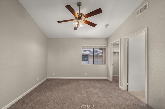 unfurnished bedroom featuring a ceiling fan, carpet, visible vents, and baseboards