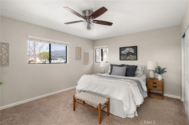 carpeted bedroom with baseboards and a ceiling fan