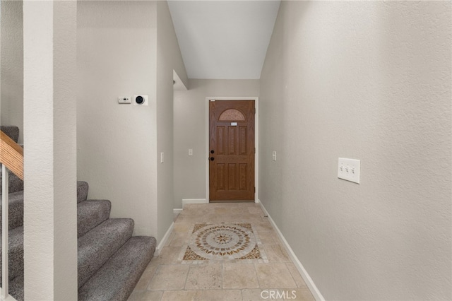 entryway with stairs and baseboards