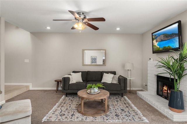 carpeted living area featuring ceiling fan, a fireplace, baseboards, and recessed lighting