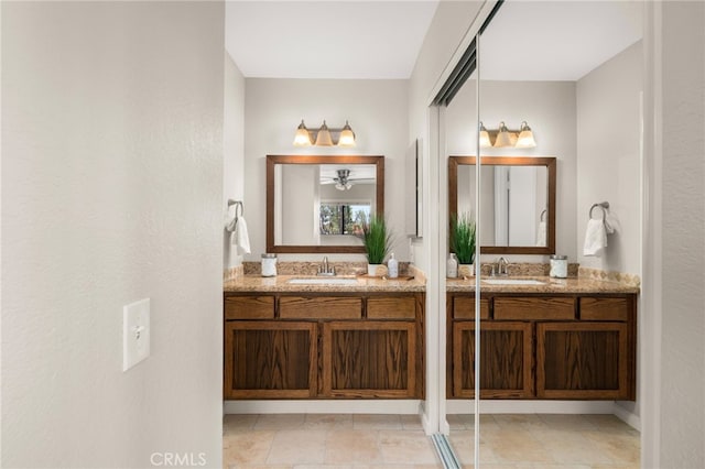 bathroom featuring a sink and two vanities