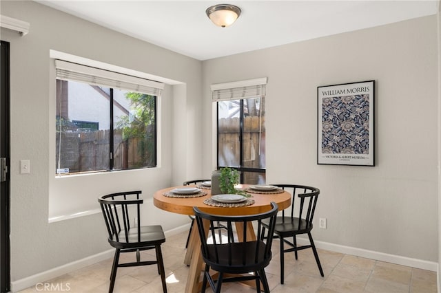 dining space featuring baseboards