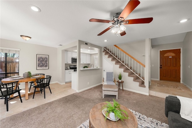 living area with light carpet, stairs, baseboards, and recessed lighting