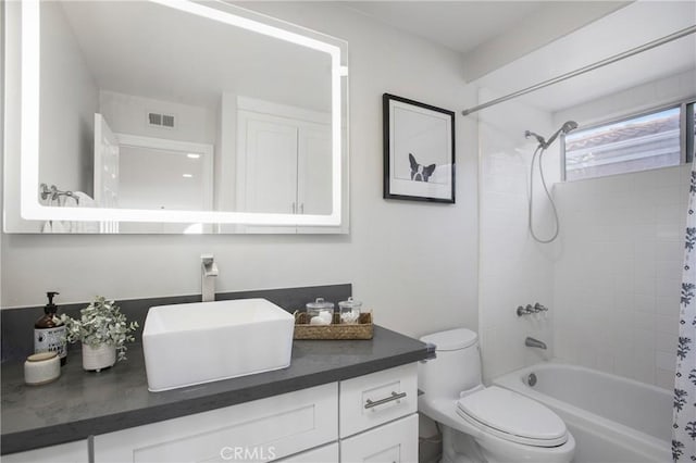 full bathroom with vanity, toilet, shower / bath combo, and visible vents