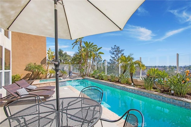 view of swimming pool with a fenced in pool, fence, and a patio area