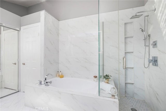 bathroom featuring a bath, marble finish floor, and a marble finish shower