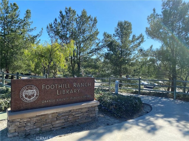 community sign featuring fence