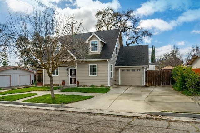 cape cod home with a garage, driveway, fence, and a shingled roof