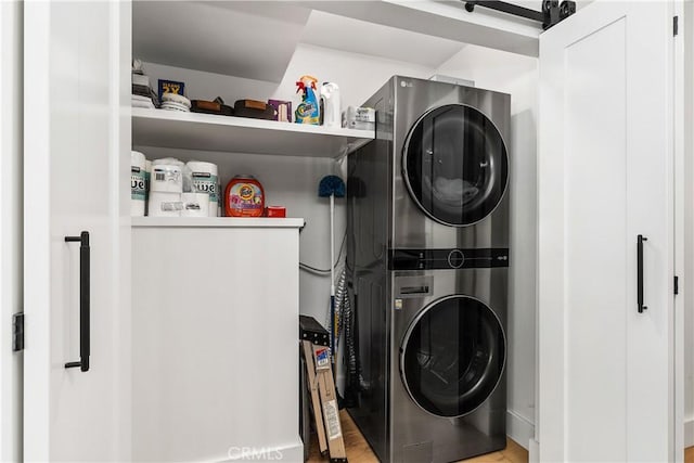 washroom featuring laundry area and stacked washer / dryer