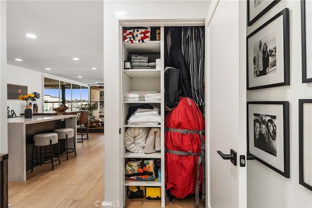 hallway with light wood-style floors and recessed lighting