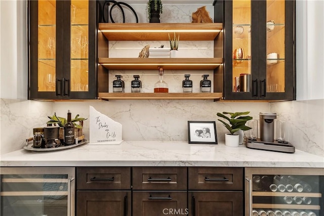 bar featuring beverage cooler, backsplash, and a dry bar