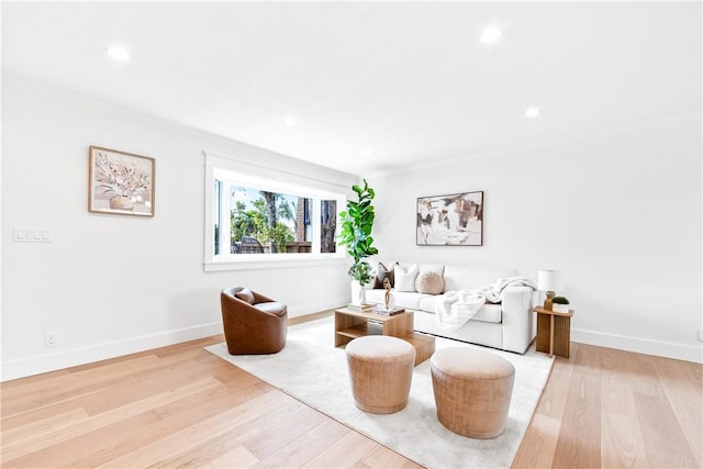 living area featuring baseboards, recessed lighting, and light wood-style floors