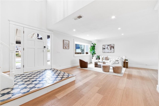 foyer entrance with light wood-style flooring, recessed lighting, visible vents, and baseboards