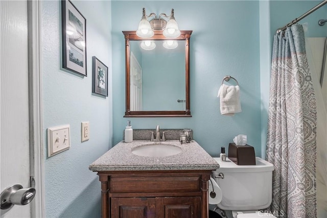 full bathroom featuring toilet, vanity, and a shower with curtain