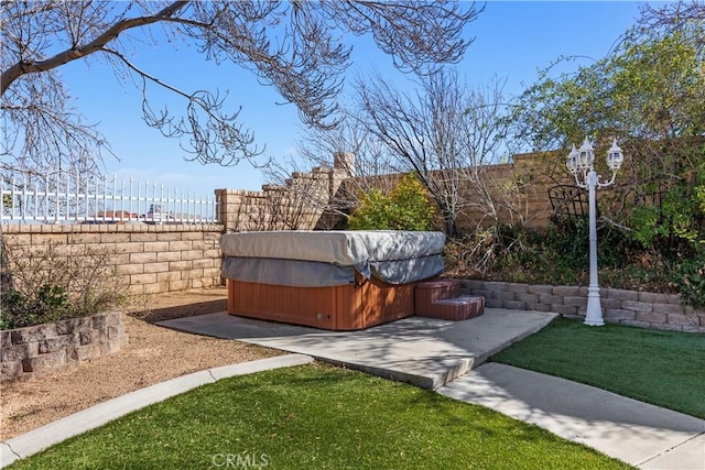 view of yard with a patio, a hot tub, and a fenced backyard