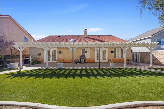 back of property featuring a tiled roof, french doors, a pergola, and stucco siding