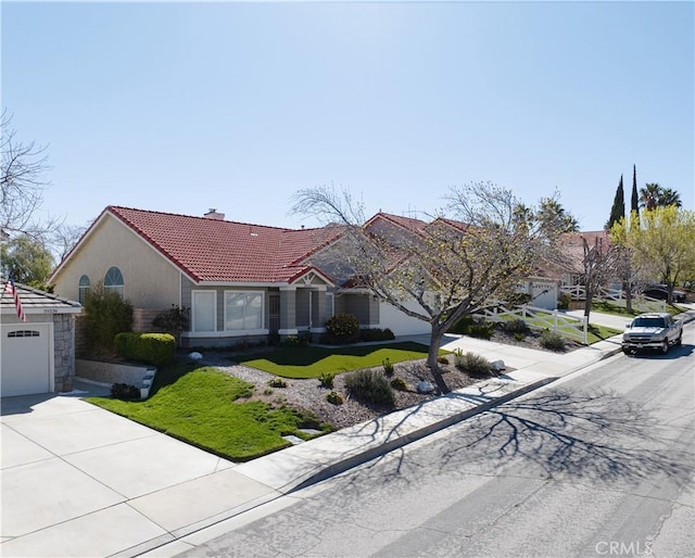 ranch-style house featuring concrete driveway, a tile roof, stucco siding, a chimney, and a garage