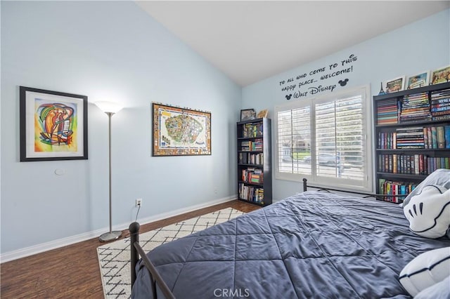 bedroom featuring wood finished floors, baseboards, and vaulted ceiling